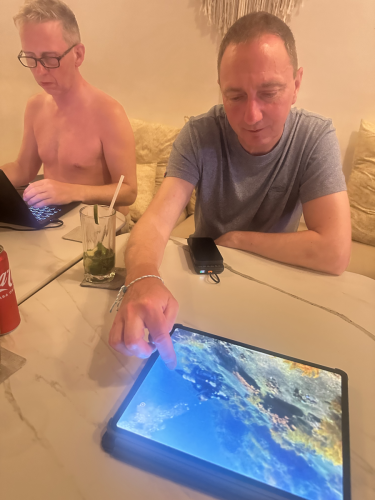 After a long day of diving, a couple Trident Warriors are relaxing and looking at the images taken during the 2025 scuba trip to Indonesia to support veterans. #tridentwarriors
