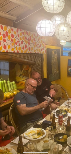 Founder of Trident Warriors and a fellow scuba diver going over notes after dinner for the next day of diving while in the Philippines in 2025