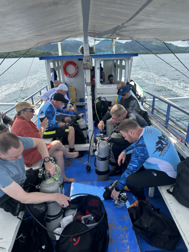 Trident Warrior scuba divers getting gear ready on the boat for their next dive while in the Philippines for the 2025 dive trip