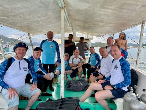 A group photo of the 2025 Trident Warriors while on the dive boat in the Philippines for the scuba trip to support veterans