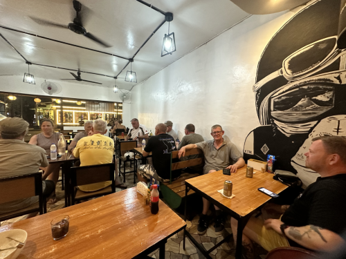 The scuba divers on the 2025 trip to the Philippines with Trident Warriors out getting something to eat after a day of diving