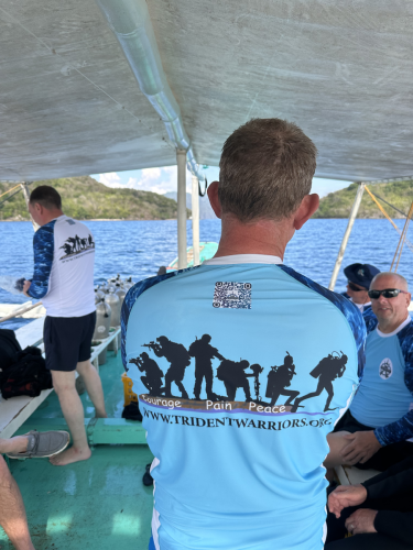 Trident Warriors scuba divers on the boat in between dives discussing the upcoming dive