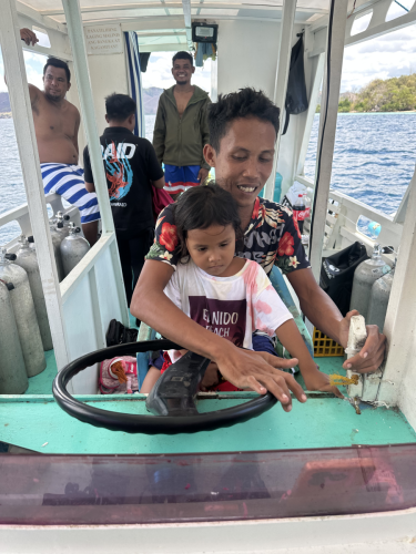 A little local help driving the scuba boat while in the Philippines with the Trident Warriors 2025 trip