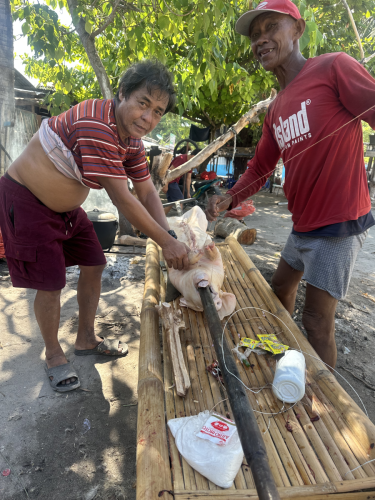 Preparing a delicious meal starts with securing the pig properly so it does not fall off into the fire
