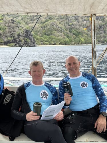 Trident Warrior founder and a fellow scuba diver on their way to the dive site during the 2025 trip to the Philippines
